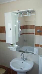 a bathroom with a sink and a mirror and a tub at Olive Grove in Kalabaka +25 photos