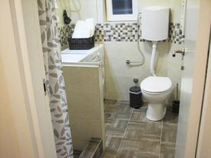 a bathroom with a toilet and a sink at Bohemian Dawn Apartment in Belgrade +14 photos