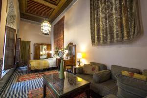 a living room with a couch and a bed at Riad Dar Cordoba in Fès