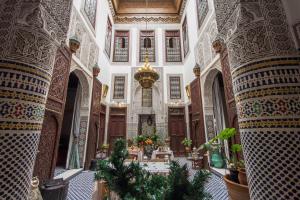 an ornate room with a table in a building at Riad Dar Cordoba in Fès