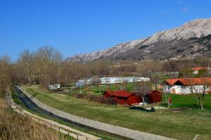 a road leading to a farm with mountains in the background at Apartments Mare I in Baška