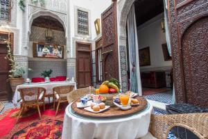 a table with fruit on it in a room at Riad Dar Cordoba in Fès