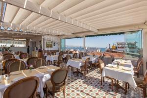 a restaurant with tables and chairs and a large window at Darussaade Hotel Old City - Sultanahmet in Istanbul