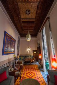 a living room with a couch and a table at Riad Dar Cordoba in Fès