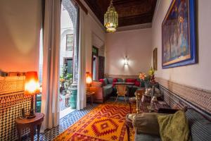 a living room with a couch and a table at Riad Dar Cordoba in Fès