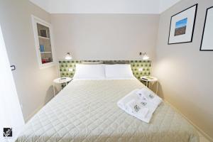 a bedroom with a large bed with towels on it at Kees Apulian Stay in Monopoli