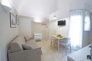 a living room with a couch and a table at Kees Apulian Stay in Monopoli