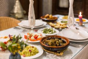 a table with plates of food on a table at Riad Dar Cordoba in Fès