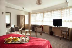 a hotel room with a tray of fruit on a bed at Hotel Biarritz Atlantique - Lycée Hotelier - Management School in Biarritz