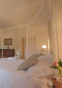 a bed with a white bedspread and pillows at B&B Palazzo Mattei in Novafeltria