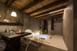 uma casa de banho com uma banheira, uma mesa e uma cadeira em Relais Bondaz em Aosta