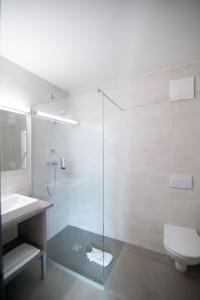 a bathroom with a shower and a toilet and a sink at Motel 267 in Sankt Pölten