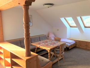 a living room with a table and a bed at Bruckerhof in Puchberg am Schneeberg