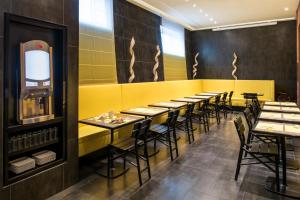 a row of tables and chairs in a restaurant at Adagio Paris 19ème Cité de la Musique in Paris