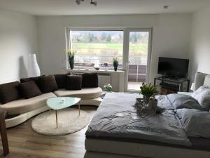 a living room with a couch and a table at Ferienwohnung Weserblick-Hameln in Hameln