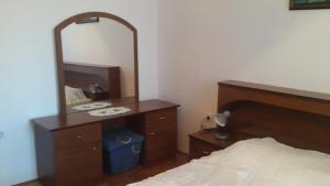 a bedroom with a mirror on a dresser and a bed at Ljubica in Žbandaj