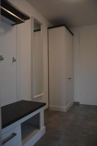 an empty room with white cabinets and a mirror at Ferienwohnung Ohanna in Bad Harzburg