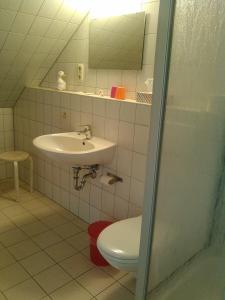 a bathroom with a sink and a toilet at Landhotel Possendorf in Weimar
