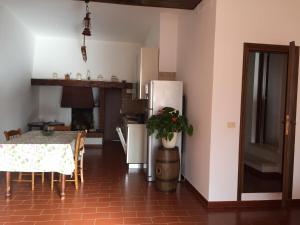 a kitchen with a table and a refrigerator at Poggio Moretto in Manciano
