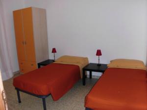 Ένα ή περισσότερα κρεβάτια σε δωμάτιο στο Villaggio Santa Rita