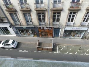 a car parked on a street in front of a building at Chambre d'hôtes La grotte de Voltaire in Nantes