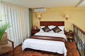 En eller flere senge i et værelse på King Parkview Hotel