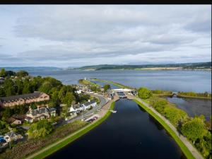 an aerial view of a town on a lake at Caledonian Canal Studio in Inverness