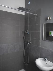 a bathroom with a shower and a sink at La Pergola Private Parking in Vezzano Ligure