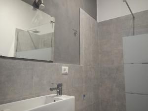 a bathroom with a sink and a mirror at La Pergola with Private Parking in Vezzano Ligure