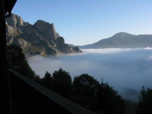 a view of a foggy valley in the mountains at La Posada de Cucayo in Dobres