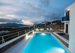 a swimming pool on the roof of a house at Mykonos Welcome Suites in Ano Mera