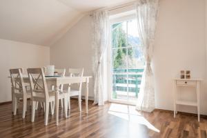 a dining room with a table and chairs and a window at Ferienwohnung Weitental in Lackenhof