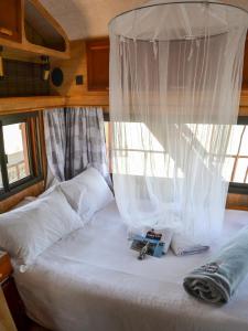 a bedroom with a bed with a canopy at Maggie May House Boat - Colchester - 5km from Elephant Park in Colchester