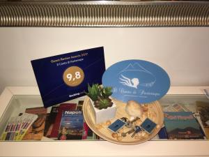 a shelf with a box of books and a plant in a bowl at Il Canto di Partenope in Naples