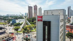 a city with a bus sign on the side of a building at ibis Goiânia in Goiânia