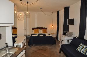 a bedroom with a bed and a couch and a sink at Anita & Garibaldi in Marsala