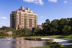 a large building next to a pond in front of a building at Four Seasons Resort Orlando at Walt Disney World Resort in Orlando