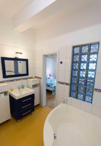 a bathroom with a bath tub and a sink and a tub at Diana's in Bucharest