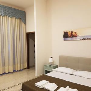 Ένα ή περισσότερα κρεβάτια σε δωμάτιο στο LA dimora di re Ferdinando