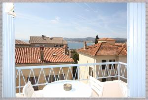 a balcony with a view of the water and buildings at La Caravelle Vue Mer et Wifi in Le Lavandou