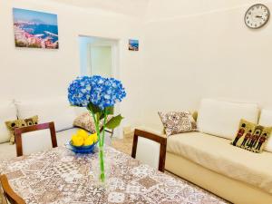 a living room with a table and a couch at Penisola Apartment in Vico Equense