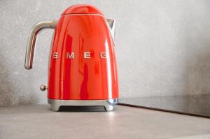 a red toaster sitting on top of a counter at My Home in Bologna - La Rossa in Bologna