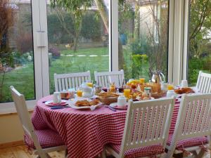 a table with breakfast food on a red and white table cloth at Wissant l'Opale in Wissant