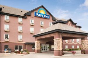 a hotel with a days inn sign on top of it at Days Inn by Wyndham Calgary Airport in Calgary