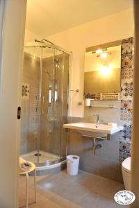 a bathroom with a sink and a shower at La Dimora del Musicante HomeGallery in Viggiano