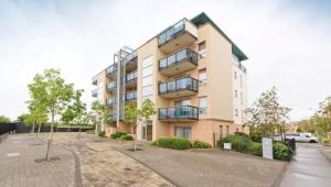 an apartment building with a parking lot in front of it at Dublin Corporate Apartment in Lucan