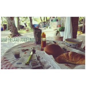 a table with a loaf of bread and a bottle of alcohol at B&B Rifugio Angelina in Vietri sul Mare +50 photos