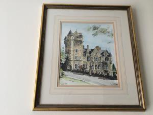 a framed picture of a castle on a wall at B2 Waterfoot Apartment in Newcastle