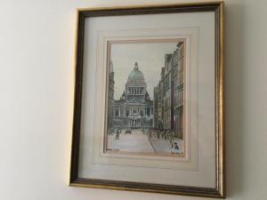 a framed picture of a building on a wall at B2 Waterfoot Apartment in Newcastle