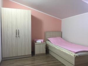 a bedroom with a bed and a cabinet at The View Apartments in Yerevan